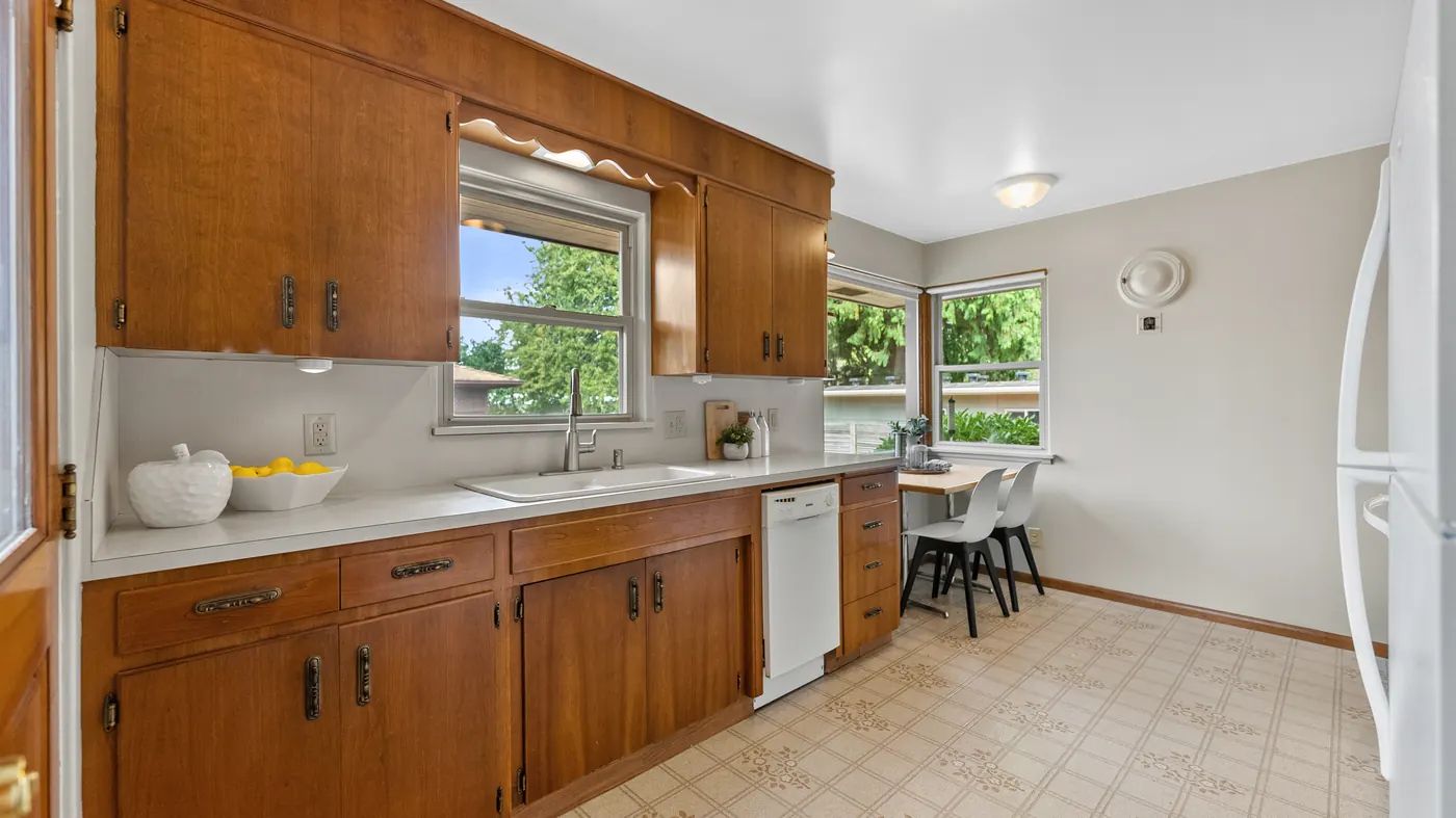 Mid-century kitchen with wood cabinets and a window over the sink